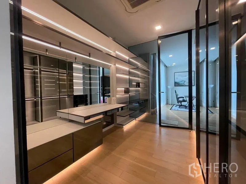 Detached House for rent in Bueng Kum, Bangkok - Walk-in dressing room with mirrored cabinets, vanity and glass doors with ambient lighting.