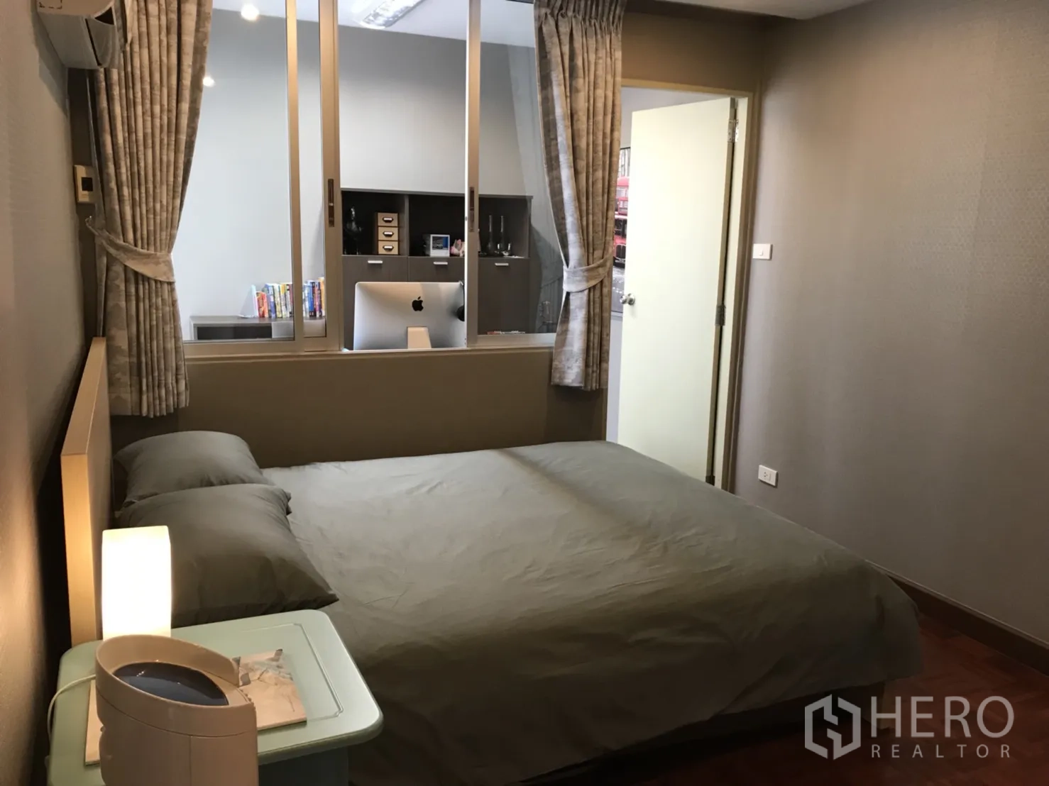 Condominium for rent in Watthana, Bangkok - Third bedroom with bed and a glass partition overlooking a study area, in neutral tones.