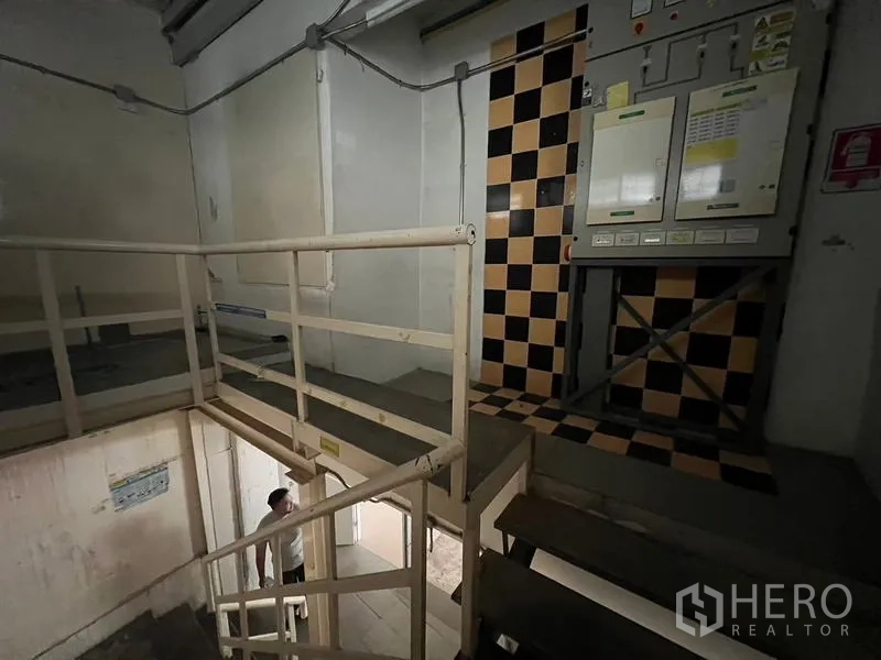 Shophouse for rent in Watthana, Bangkok - Mezzanine platform with safety rails and electrical control panels.