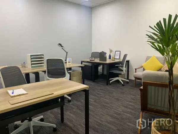 Office Space for rent in Sathon, Bangkok - Private office suite featuring multiple workstations and a small sofa seating area.