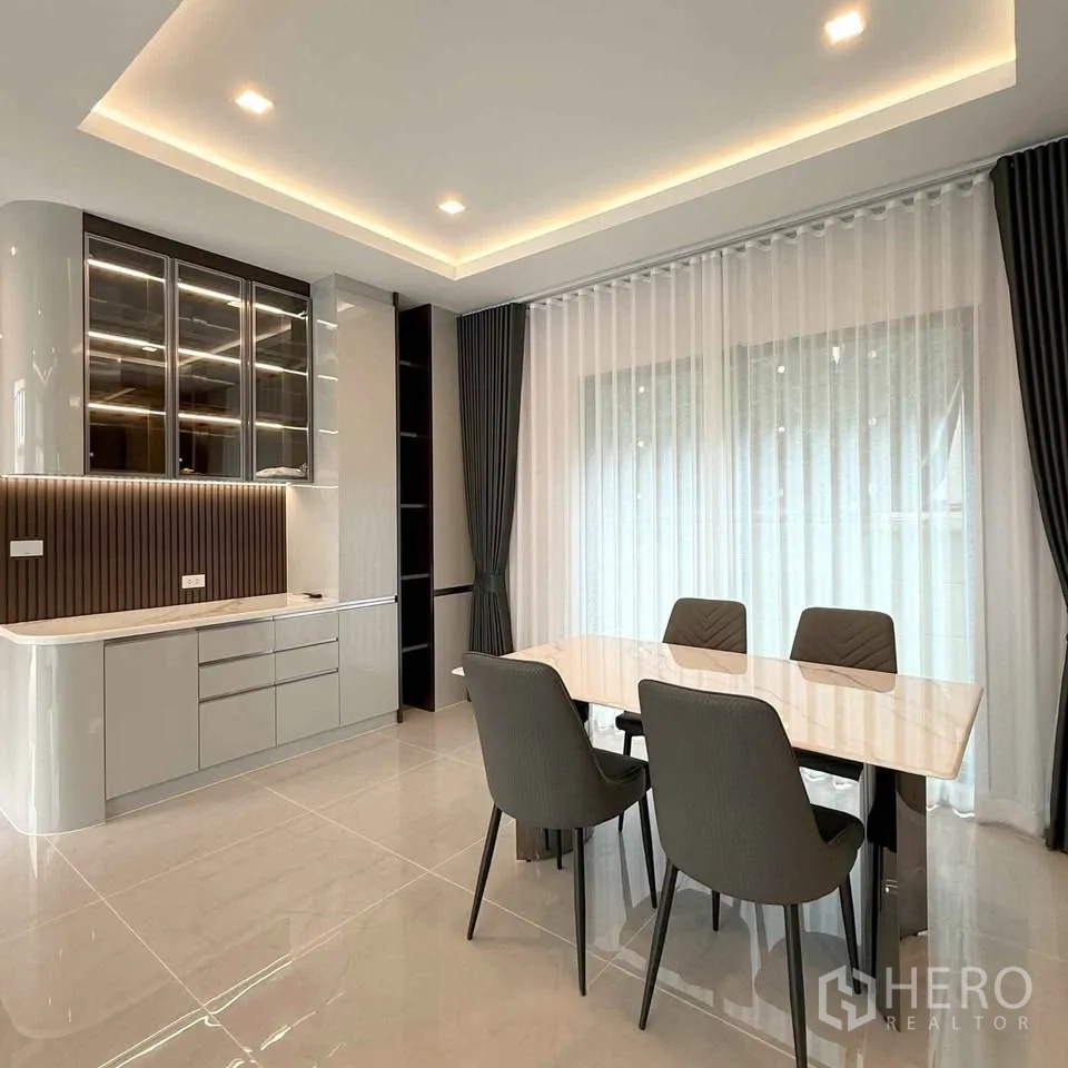Detached House for rent in Bang Phli, Samut Prakan - Dining area with four chairs, marble table and backlit cabinetry.