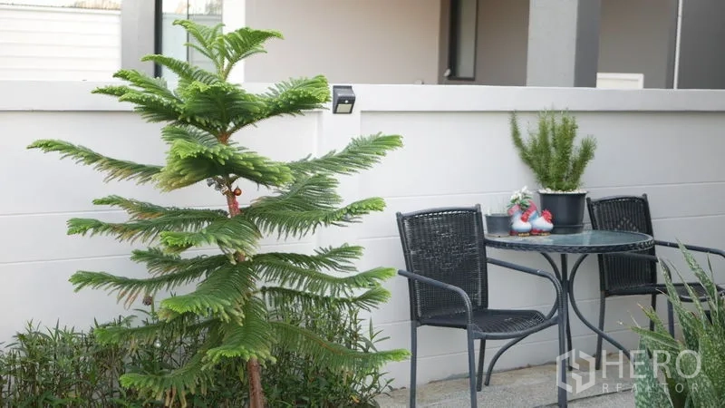 Detached House for rent or sale in Bang Bo, Samut Prakan - Small patio with two-seat bistro set and potted plants.