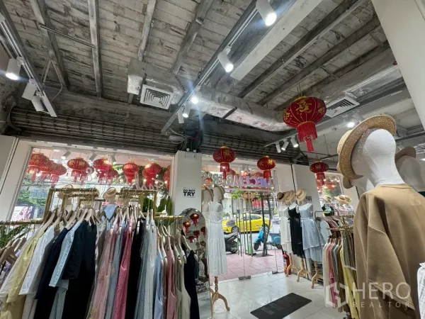 Shophouse for rent in Samphanthawong, Bangkok - Ground-floor retail area with clothing racks, track lighting and exposed industrial ceiling.
