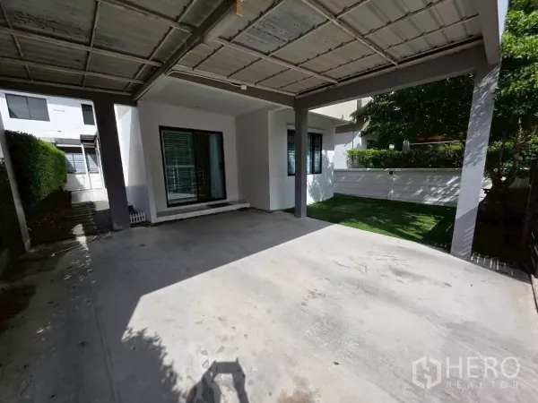 Detached House for rent or sale in Samut Prakan - Spacious covered two-car parking area with sliding glass doors to the home.