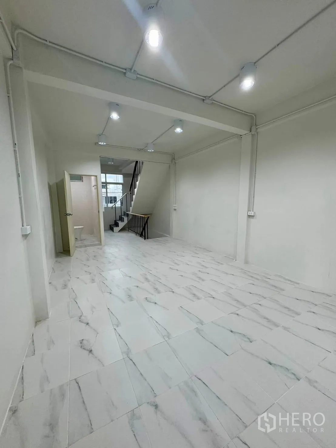 Shophouse for rent in Sathon, Bangkok - Ground-floor open space leading to staircase and bathroom.