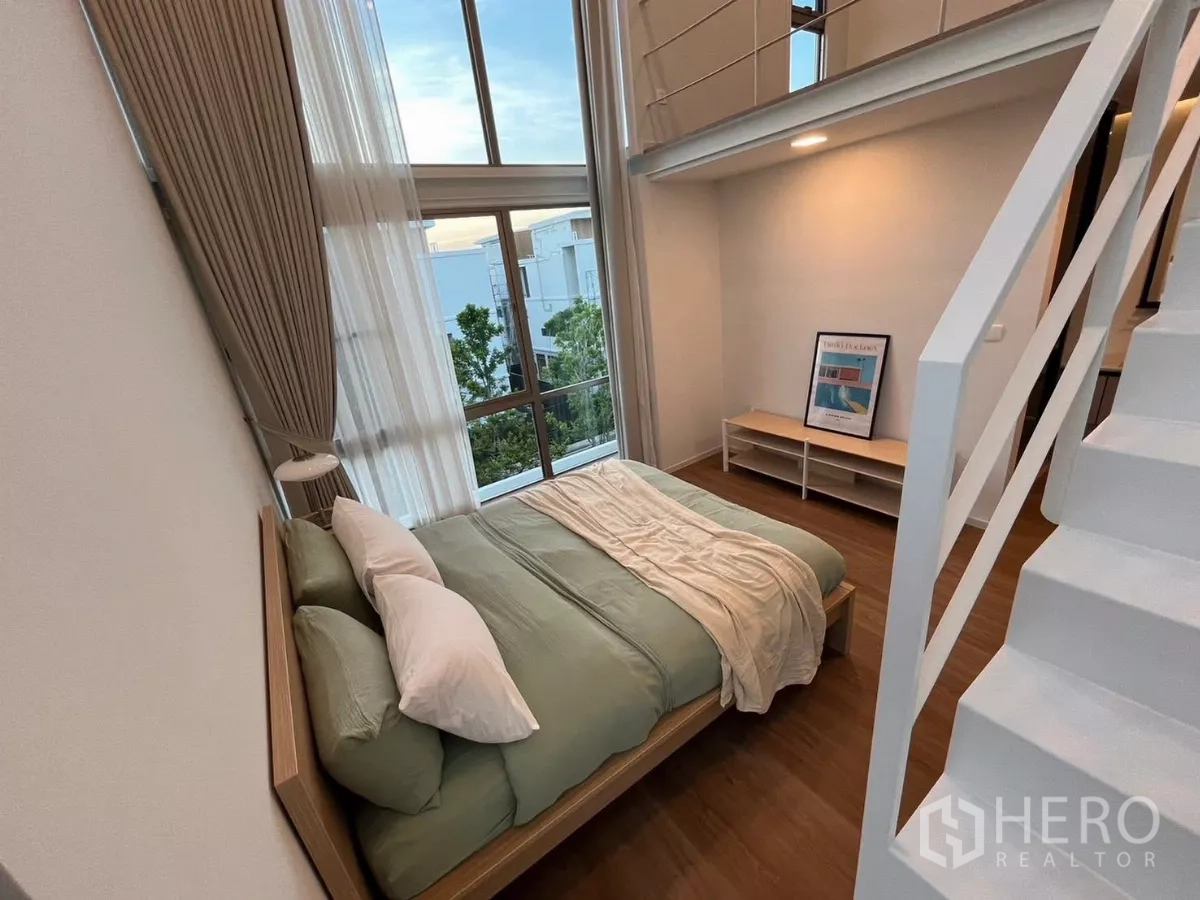 独立式住宅 出租在Saphan Sung, Bangkok - 挑高卧室，落地窗与阁楼式空间。