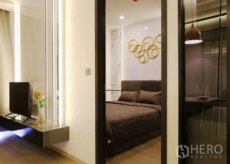 Condominium for rent in Watthana, Bangkok - View from living to bedroom through sliding door, TV console and glass partition.