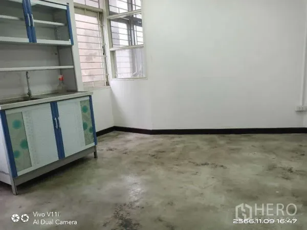 Office Space for rent in Bang Na, Bangkok - Corner pantry with stainless sink, blue-white cabinets and sliding windows.