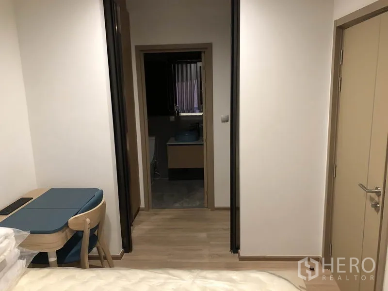 คอนโด ให้เช่าในWatthana, Bangkok - โถงจากห้องนอนไปห้องน้ำ มีมุมโต๊ะทำงานบิลต์อินและพื้นไม้โทนอ่อน