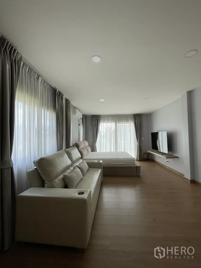Detached House for rent in Bang Phli, Samut Prakan - Master bedroom side view with TV wall and expansive curtains.