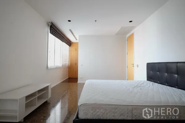 公寓 出租在Bang Rak, Bangkok - 明亮卧室，大窗、皮质床头与内置衣柜。