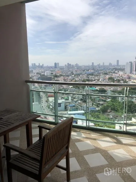 Condominium for rent in Bang Kho Laem, Bangkok - High-floor balcony with glass railing, outdoor seating, and expansive Bangkok city skyline view.