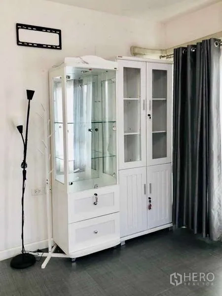 Detached House for rent or sale - Display and storage cabinets beside floor-to-ceiling curtains.