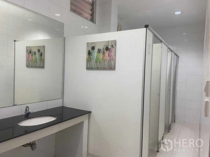 Office Space for rent in Saphan Sung, Bangkok - Restroom with multiple stalls and a long vanity with mirror