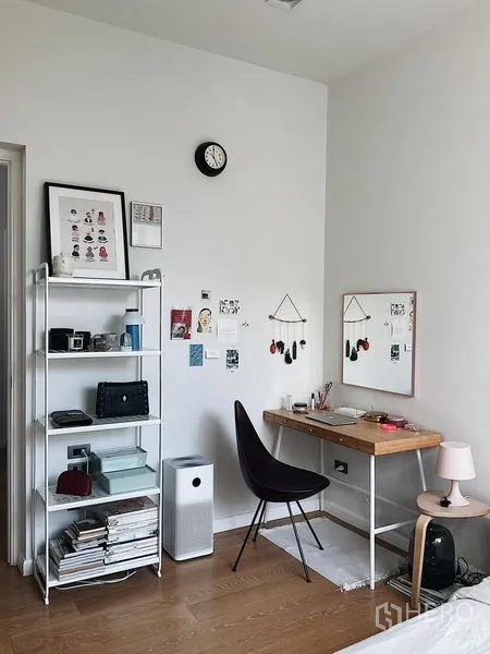 Detached House for sale in Bang Kapi, Bangkok - Study nook with shelving unit, desk, mirror, and wall clock.