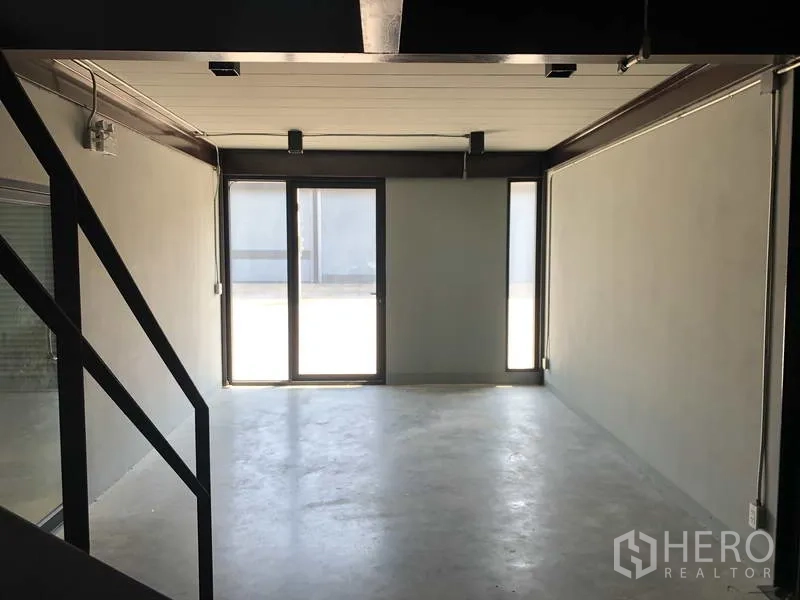 货栈 出租在Bang Phli, Samut Prakan - 一层可作展厅或办公室的空间，推拉玻璃门与水泥地。