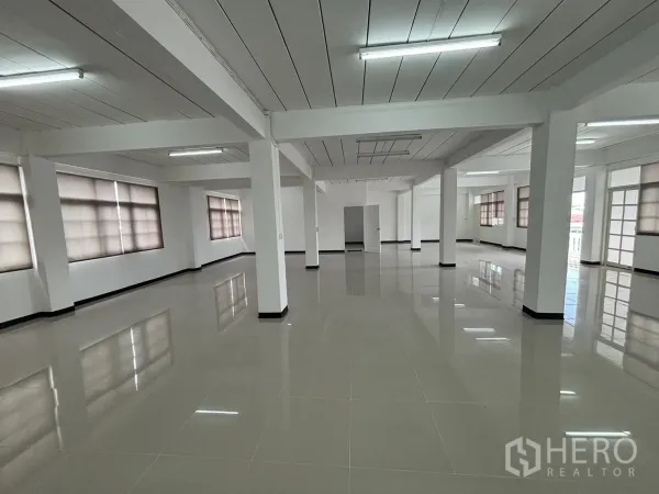 Home Office for rent in Phra Khanong, Bangkok - Open office level with roller blinds, white pillars and polished tile floor.