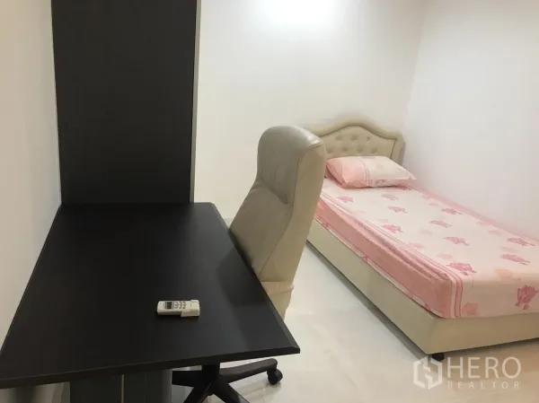 Condominium for rent in Khlong Toei, Bangkok - Compact bedroom with single bed in pink bedding, study desk, and office chair.