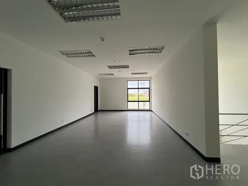 Warehouse for rent in Chon Buri - Flexible office room with natural light and grey tile flooring.
