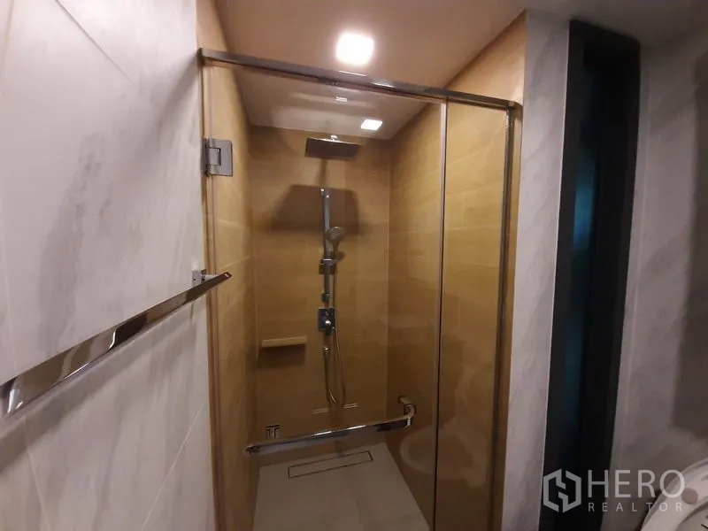คอนโด ให้เช่าหรือขายในWatthana, Bangkok - ภาพใกล้ฝักบัวเรนชาวเวอร์ในตู้กระจก ผนังโทนไม้