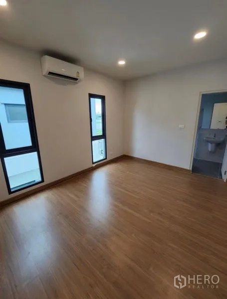 Detached House for rent in Bang Phli, Samut Prakan - Open-plan living and dining space with glossy tile floors and stair access.