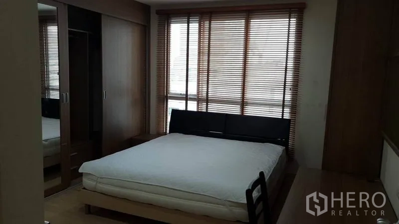 公寓 出租在Bang Rak, Bangkok - 卧室配大床，落地窗配百叶帘，内置镜面衣柜。