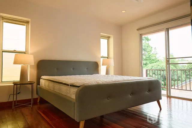 บ้าน ให้เช่าในWatthana, Bangkok - ห้องนอนเตียงหุ้มผ้าสีเทา พร้อมประตูออกระเบียง