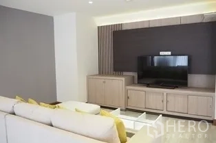 Condominium for rent in Pathum Wan, Bangkok - Living room TV wall with light wood cabinetry in Bangkok condominium.