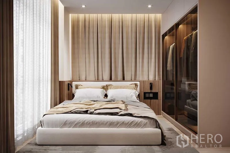 Condominium for rent in Bang Rak, Bangkok - Master bedroom with upholstered bed, pleated headboard, warm ambient lighting and glass-front wardrobe.