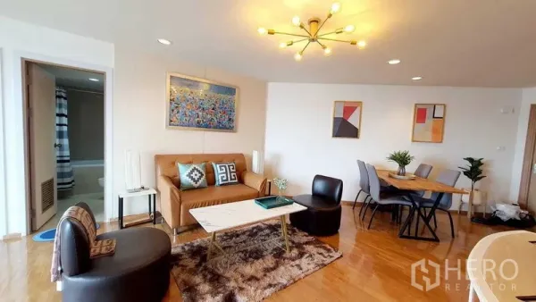 Condominium for sale in Bang Kho Laem, Bangkok - Living room facing dining corner with chandelier lighting and modern decor.