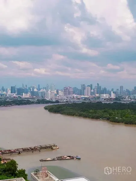 公寓 出售在Yan Nawa, Bangkok - 宽幅河流与城市天际线的全景，云层天空