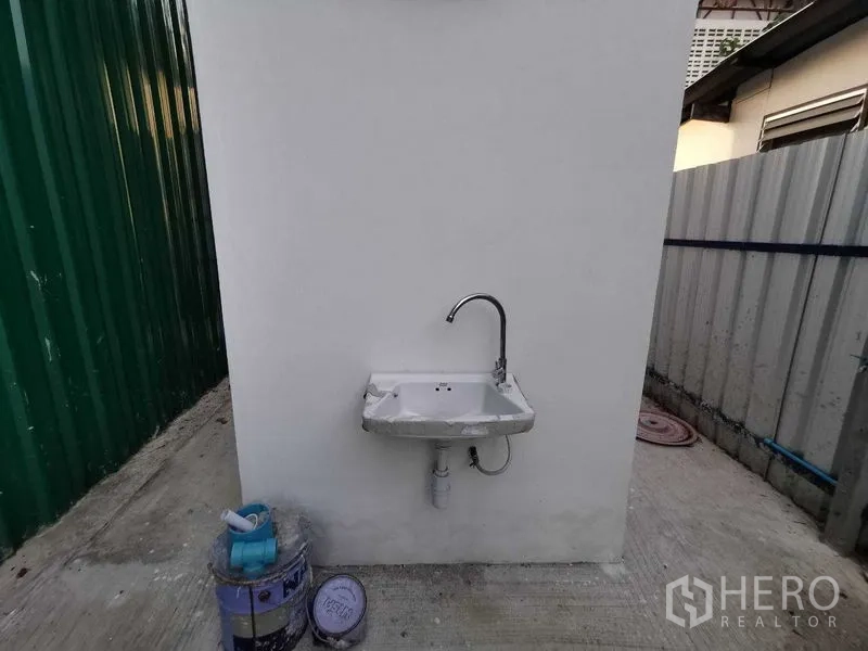 Warehouse for rent in Bang Na, Bangkok - Close-up of wall-mounted utility sink and faucet