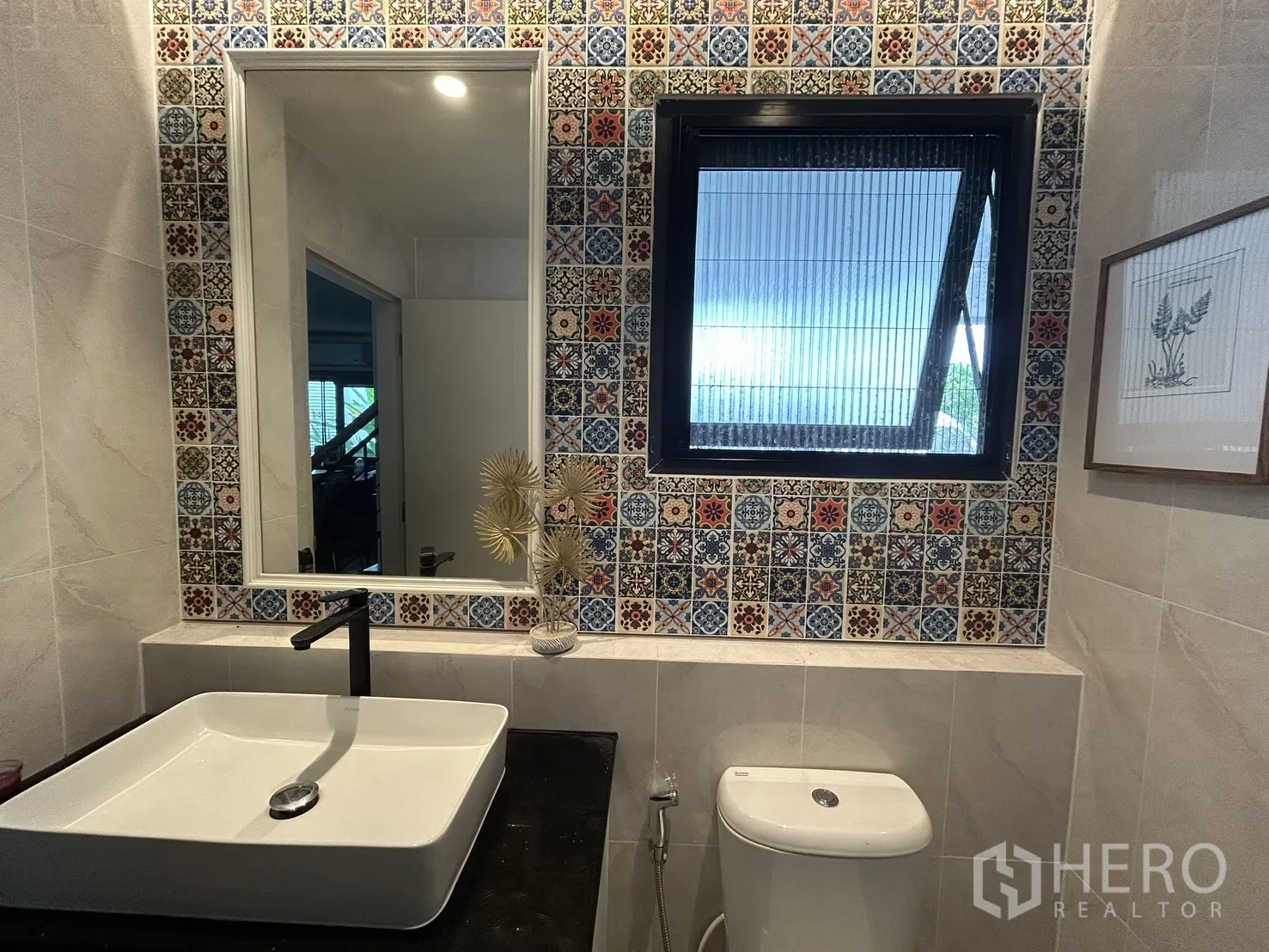 Detached House for rent in Bang Phli, Samut Prakan - Close-up of vanity and window framed by colorful patterned tiles.