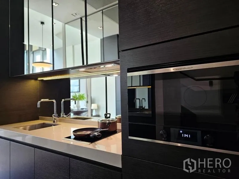 Condominium for rent - Built-in kitchen with induction cooktop, sink, and stainless oven.