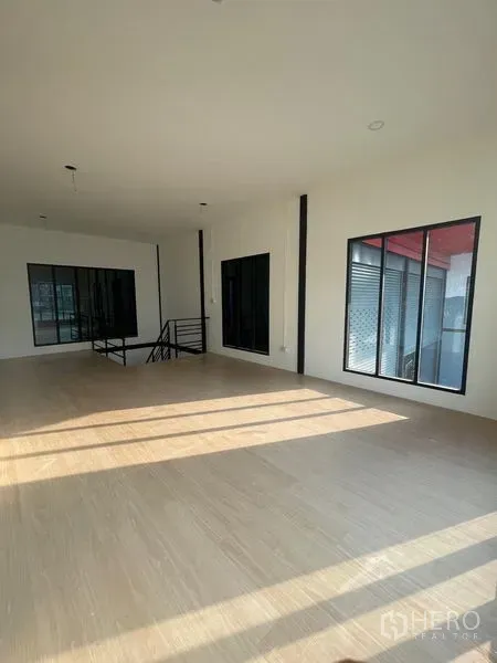 Warehouse for rent in Bang Kapi, Bangkok - Bright upstairs office with large windows and wood-look flooring inside the warehouse.