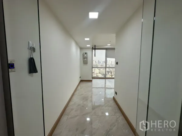 Office Space for rent - Bright corridor entry with glossy tiles leading to an office and skyline view.