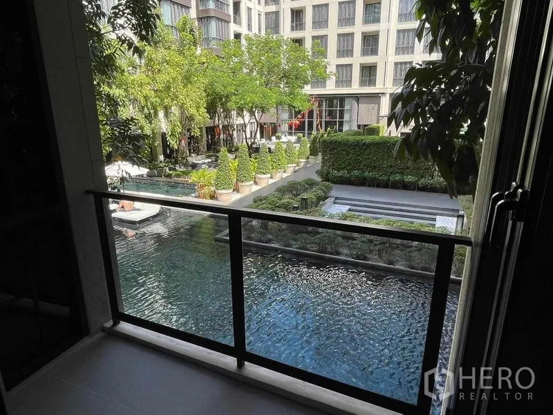 Condominium for rent - Balcony view over a resort-style swimming pool and landscaped courtyard within the condominium.