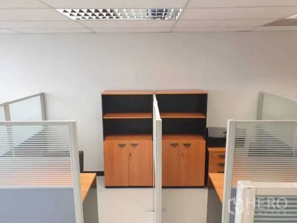 Office Space for rent in Chatuchak, Bangkok - Open-plan work area with cubicles and wooden storage cabinets.