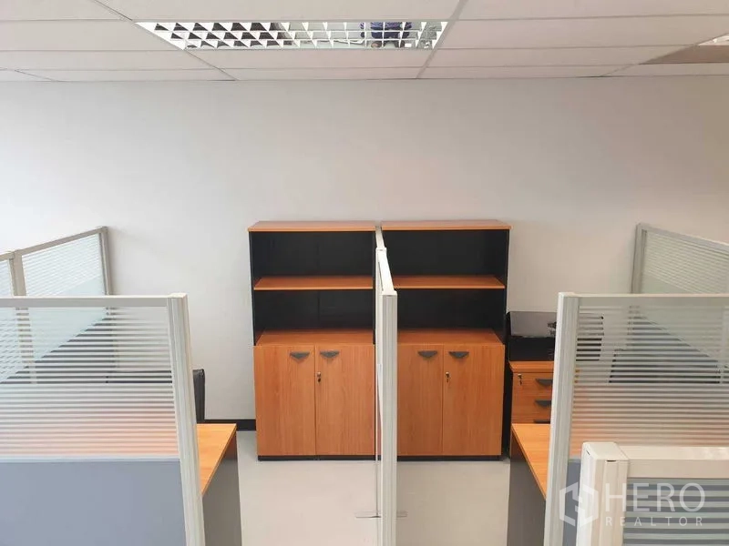 Office Space for rent in Chatuchak, Bangkok - Open-plan work area with cubicles and wooden storage cabinets.