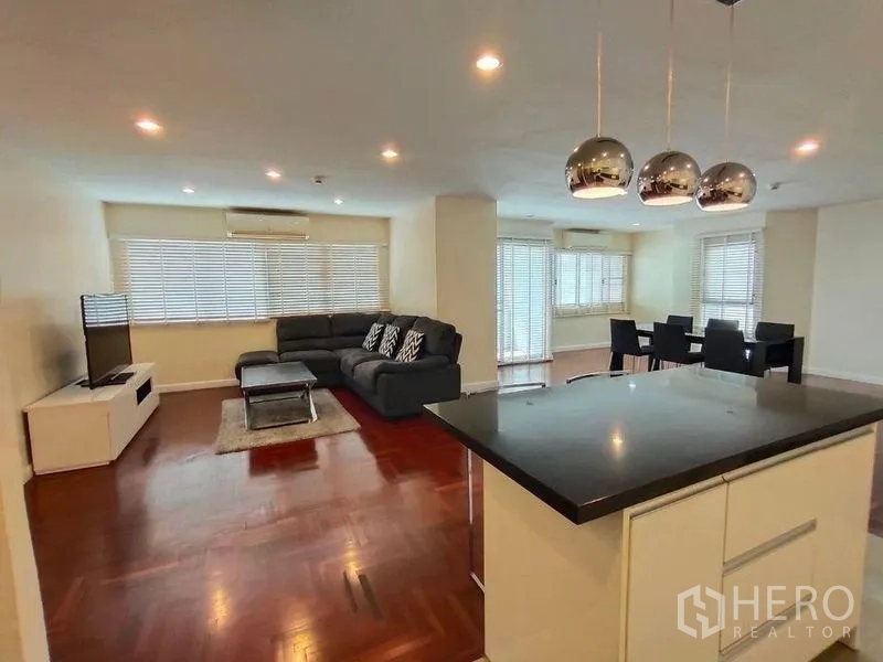 Condominium for rent or sale in Bang Rak, Bangkok - Open living–dining area with L‑shaped sofa, dining set, and wide windows.