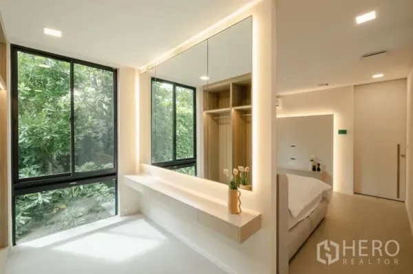 Detached House for rent in Saphan Sung, Bangkok - Dressing area with full-length mirror and garden views through large windows.