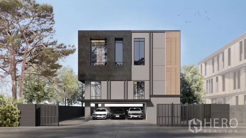 Home Office for sale in Prawet, Bangkok - Front view of a gated contemporary home office with tall windows and multiple covered parking bays.