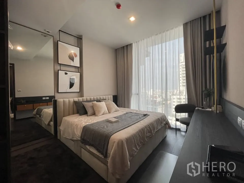 Condominium for rent in Watthana, Bangkok - Bright bedroom with king bed, floor-to-ceiling windows, and sweeping city views.