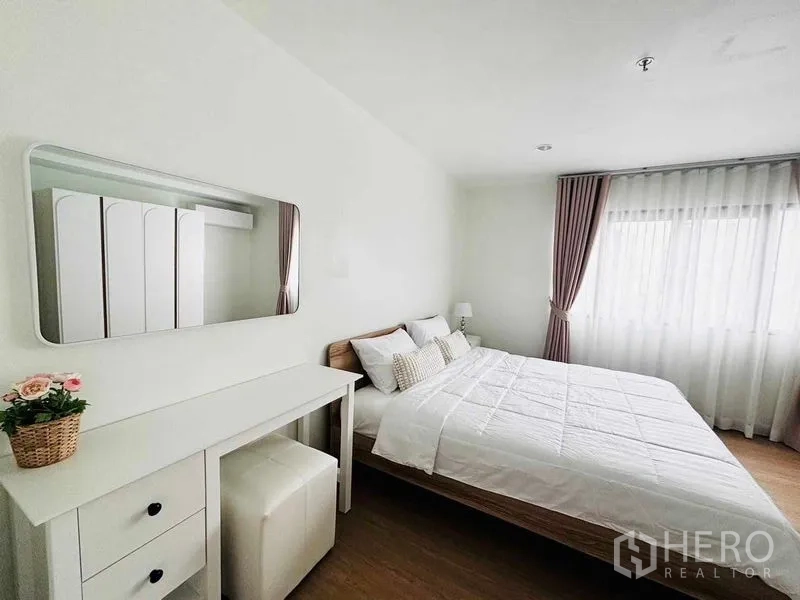 Condominium for rent in Watthana, Bangkok - Master bedroom angle showing wardrobe, mirror vanity and soft natural light.