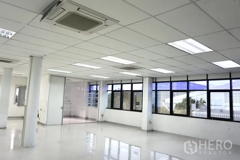 Office Space for rent in Lat Krabang, Bangkok - Spacious corner office area with large windows, ceiling cassette AC units and polished floors.