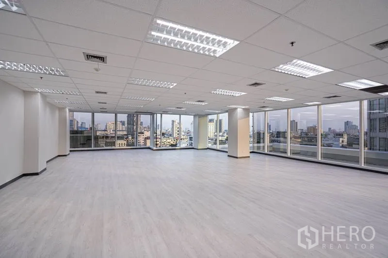 Office Space for rent in Bang Rak, Bangkok - Bright corner office with full-height windows, city skyline views and LED grid lighting in Silom CBD.