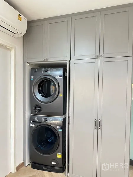 Detached House for rent or sale - Laundry closet with stacked washer and dryer in custom cabinetry.