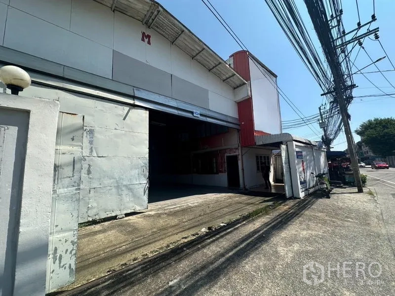 Warehouse for rent in Suan Luang, Bangkok - Loading ramp and wide roller door entrance to the warehouse along the main road.
