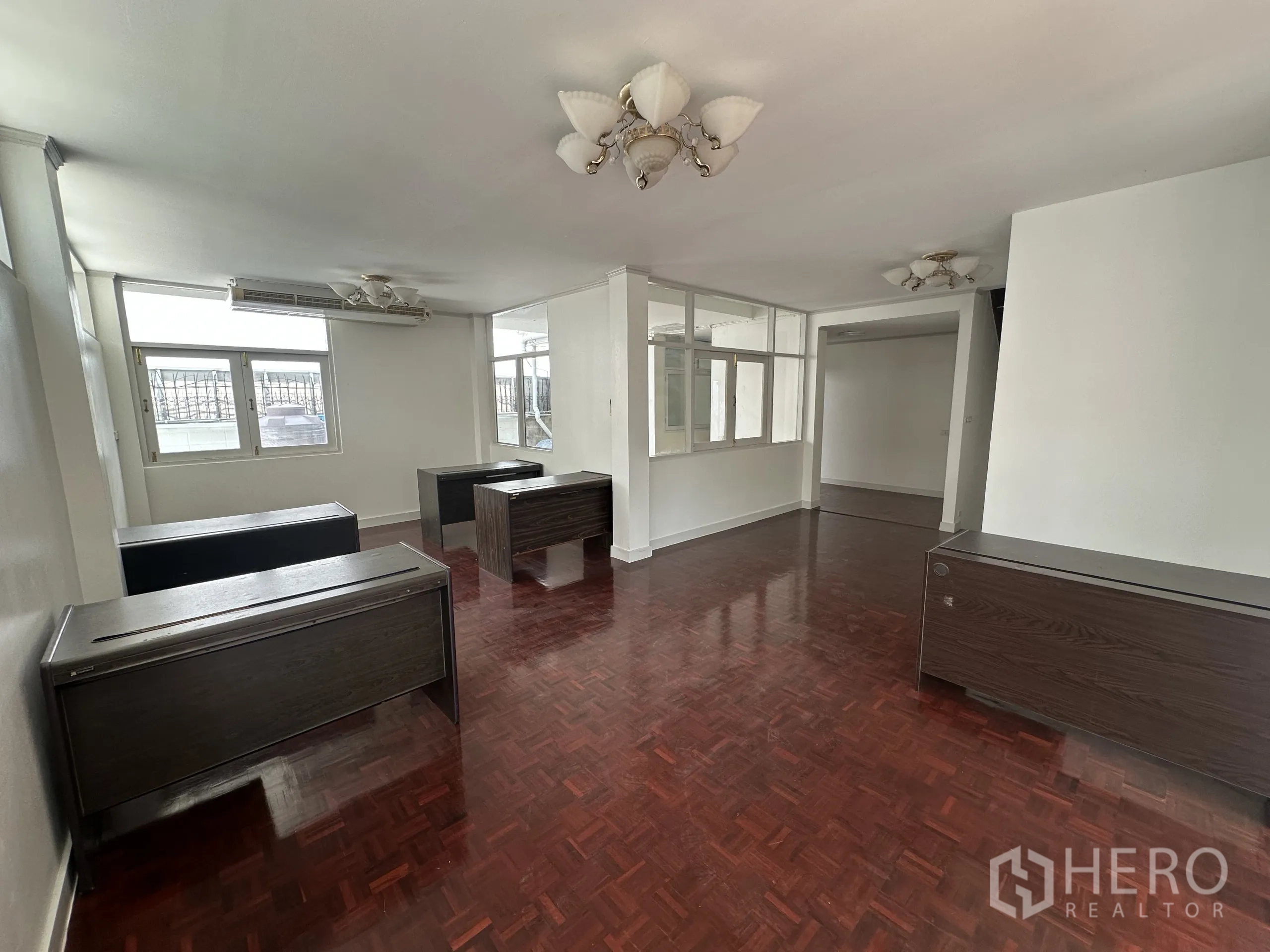 Home Office for rent in Watthana, Bangkok - Large office room with multiple desks, natural light and air-conditioning units.