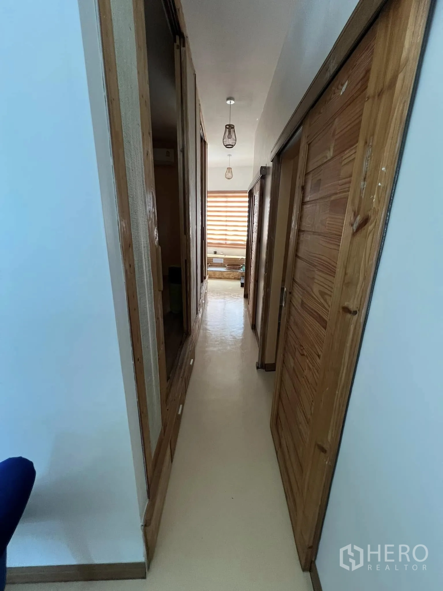 Retail Space for rent in Lat Phrao, Bangkok - Hallway with wooden doors leading to multiple treatment rooms.